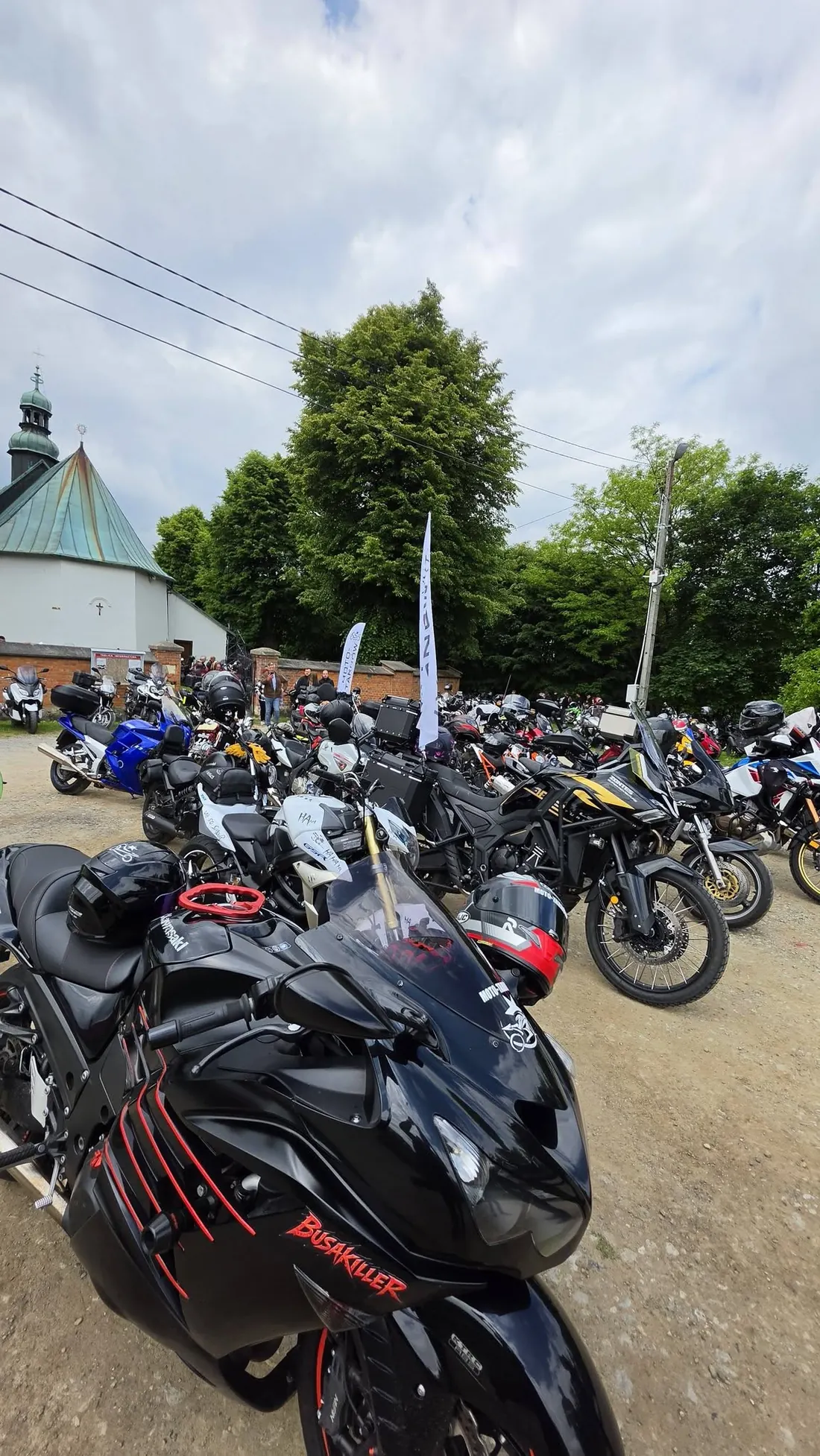 Motocykle grupy zaparkowane pod kościołem podczas MotoNiedzieli